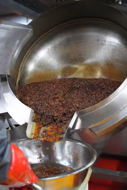 Sauce being transferred from a cooking vessel